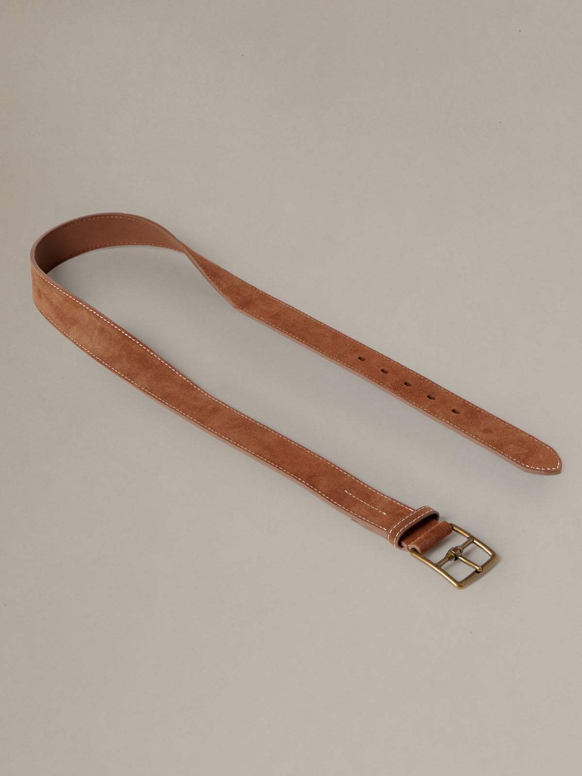J.McLaughlin Suede Belt in brown suede with a brass buckle and stitched edges shown laid flat for timeless everyday style