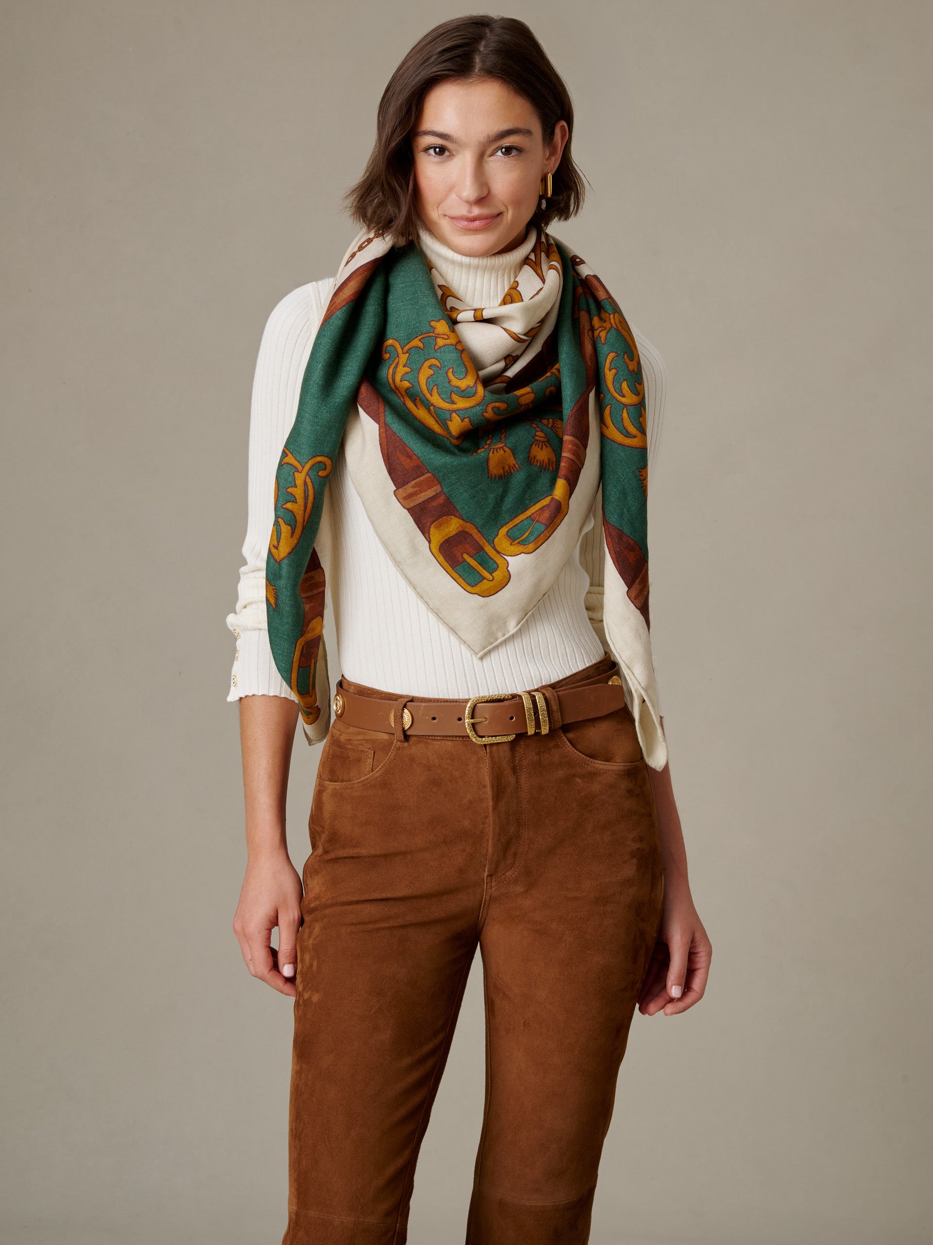 J.McLaughlin The Charlotte Scarf in Gilded Bridle Border draped on a woman in a soft cashmere silk blend with classic green and gold motifs