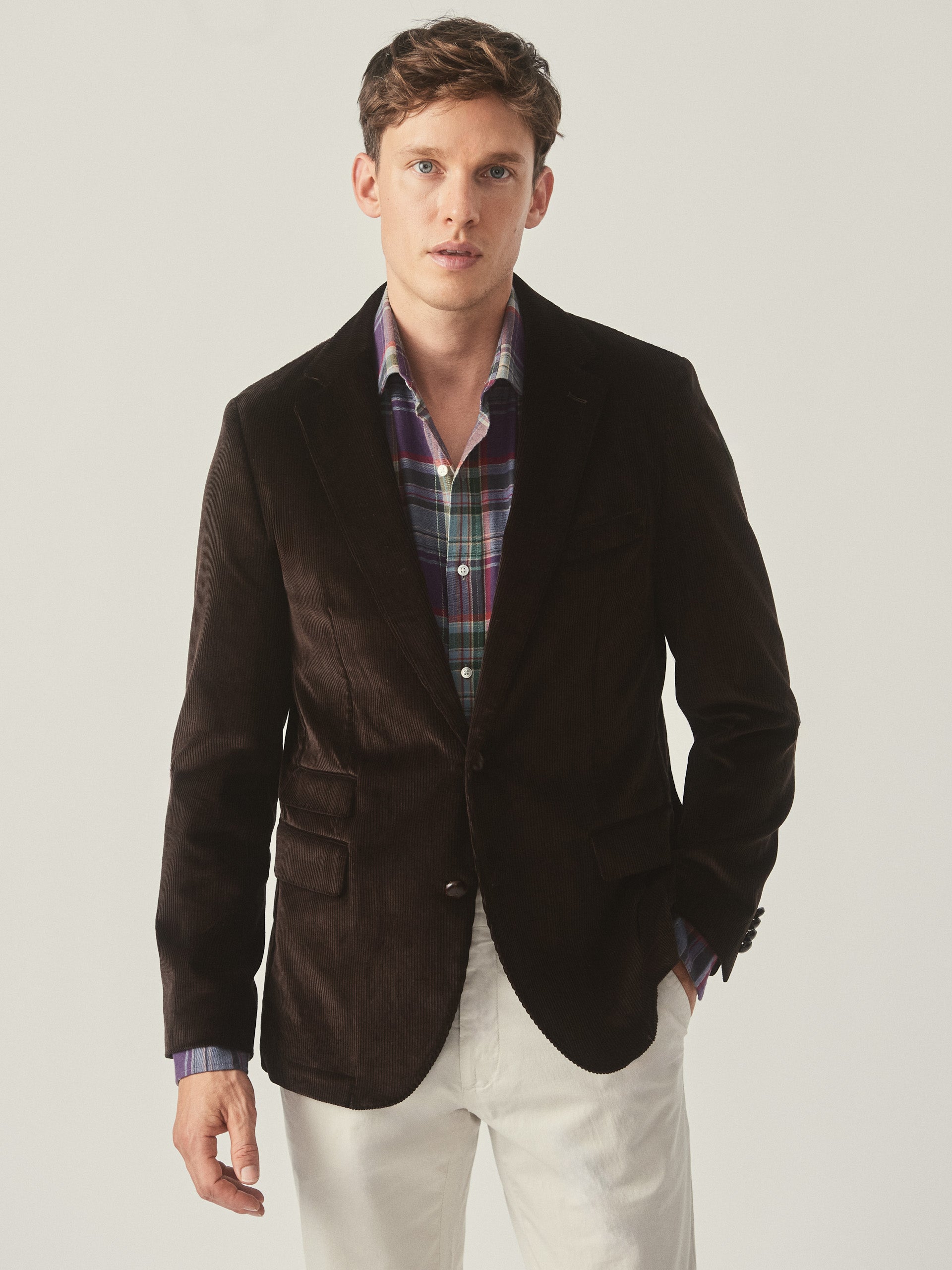 Model wearing J.McLaughlin Suffolk blazer in brown made with cotton corduroy.