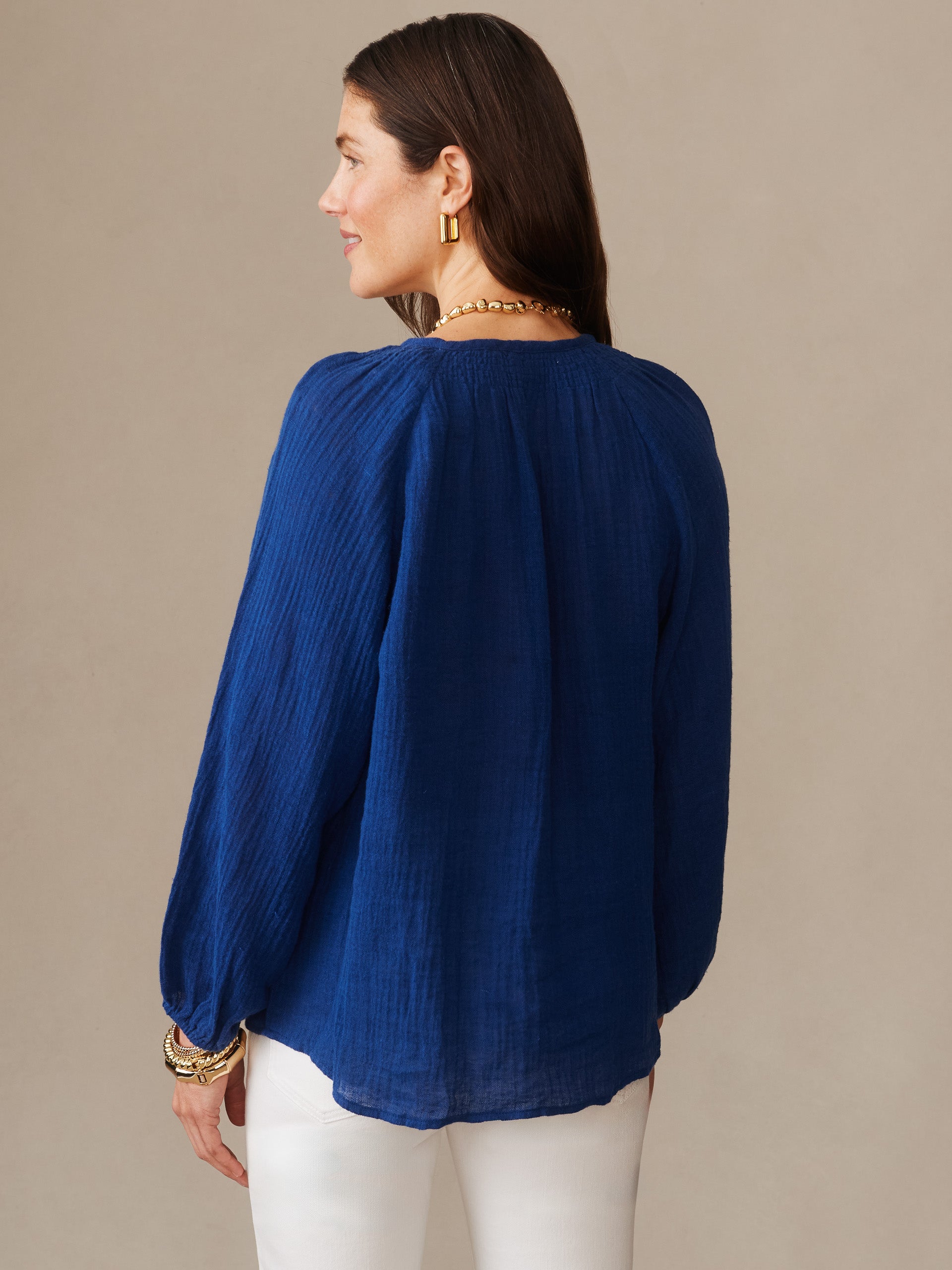Woman wearing a nautical navy Tatiana Linen Blouse by J.McLaughlin, showcasing effortlessly stylish and enduring designs crafted with innovative fabrics for a destination of defining style. Life, Well-Lived.