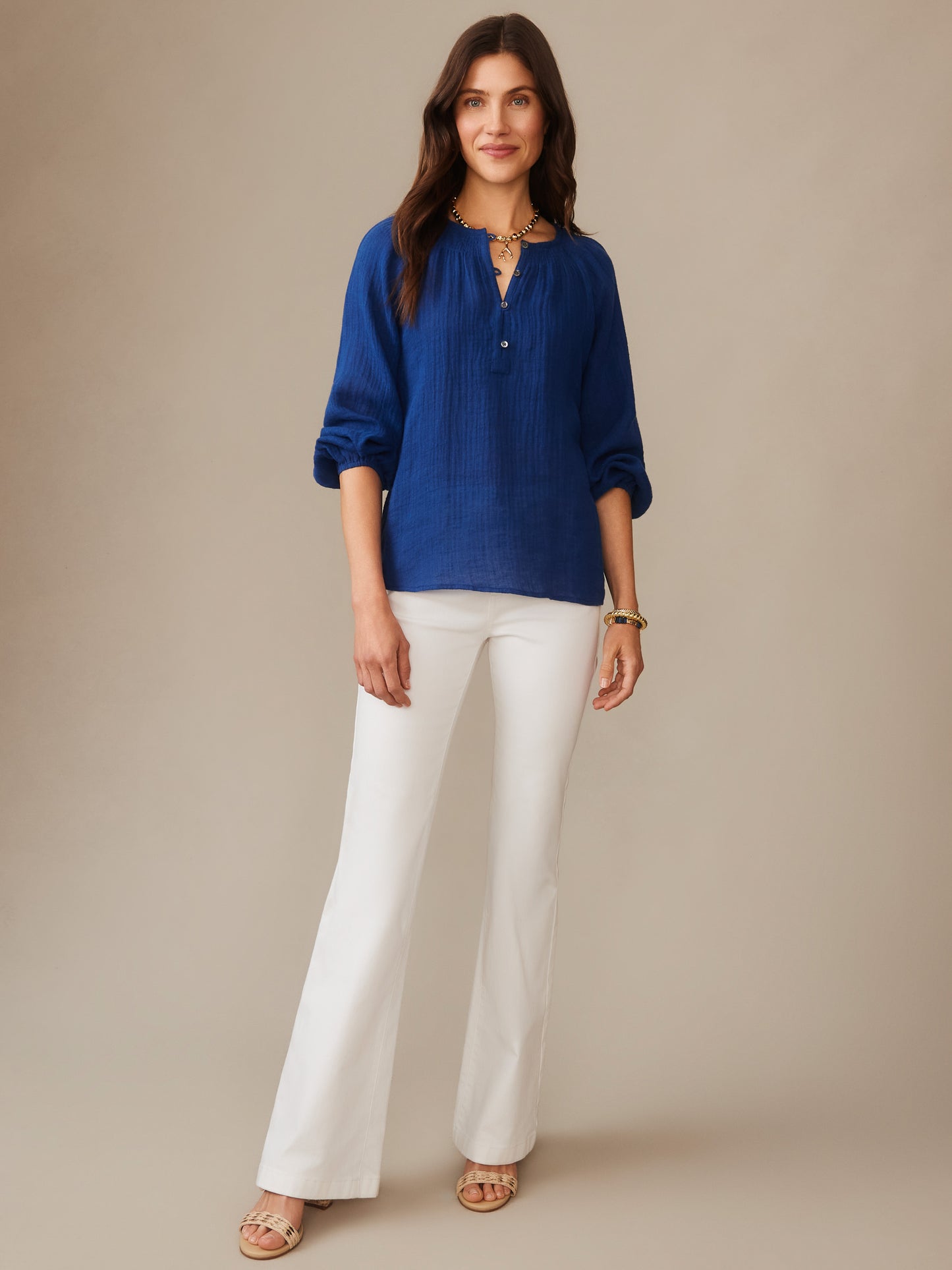 Woman wearing a nautical navy Tatiana Linen Blouse by J.McLaughlin paired with white pants, showcasing effortlessly stylish, enduring designs in innovative fabrics.