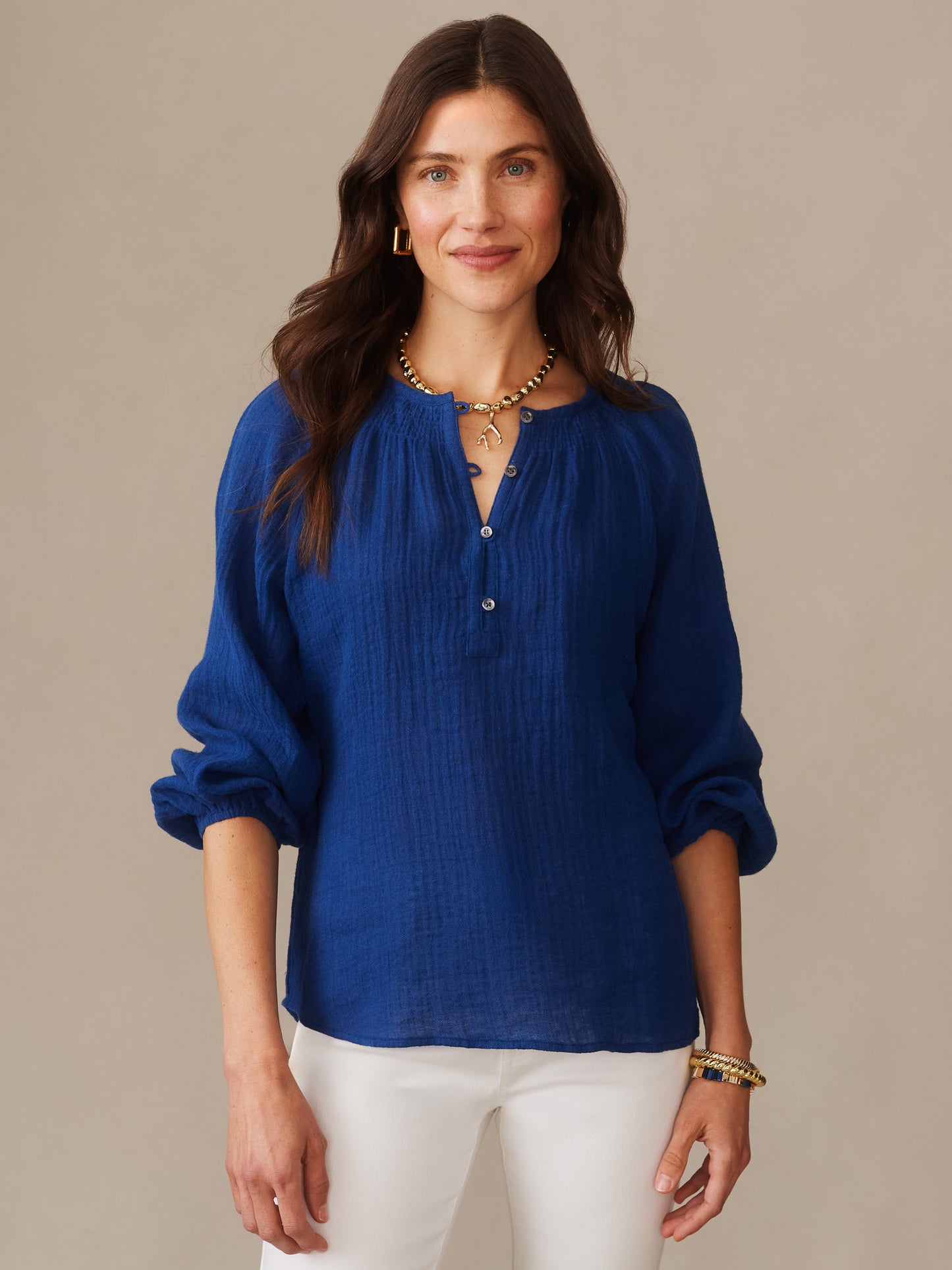 Woman wearing a nautical navy Tatiana Linen Blouse by J.McLaughlin, featuring lightweight fabric and a relaxed fit, embodying effortlessly stylish and enduring designs.