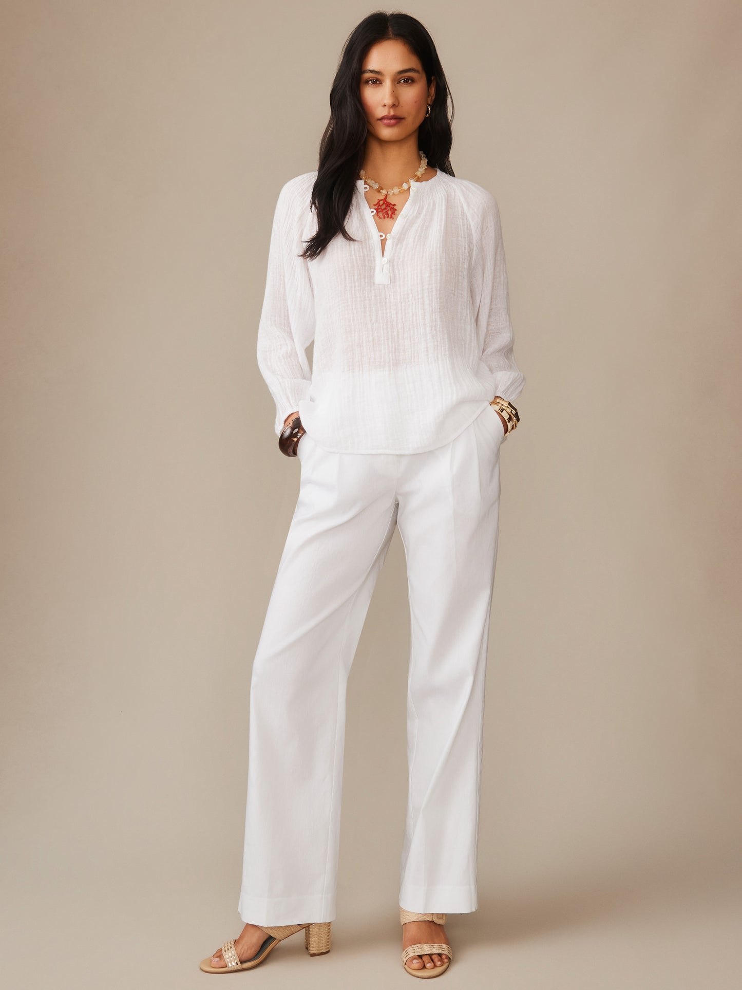 Woman wearing the Tatiana Linen Blouse by J.McLaughlin, styled with white pants and accessories, showcasing effortlessly stylish and enduring designs in innovative fabrics, a destination for defining style. Life, Well-Lived.