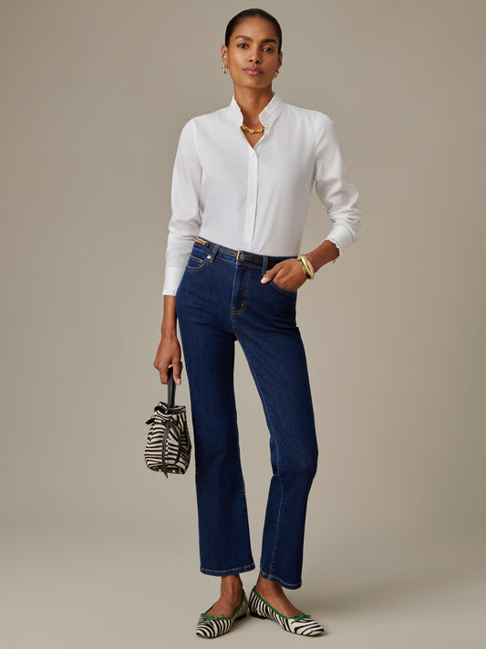 Woman wearing white blouse and Elvira Jeans by J.McLaughlin, styled with striped flats and a matching small handbag, showcasing effortlessly stylish, timeless design.
