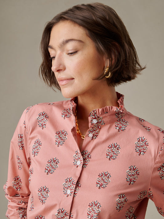 Woman wearing a pink Tess Ruffle Collar Shirt in Heritage Bloom by J.McLaughlin featuring a delicate floral print and a softly ruffled collar, embodying enduring elegance and style.