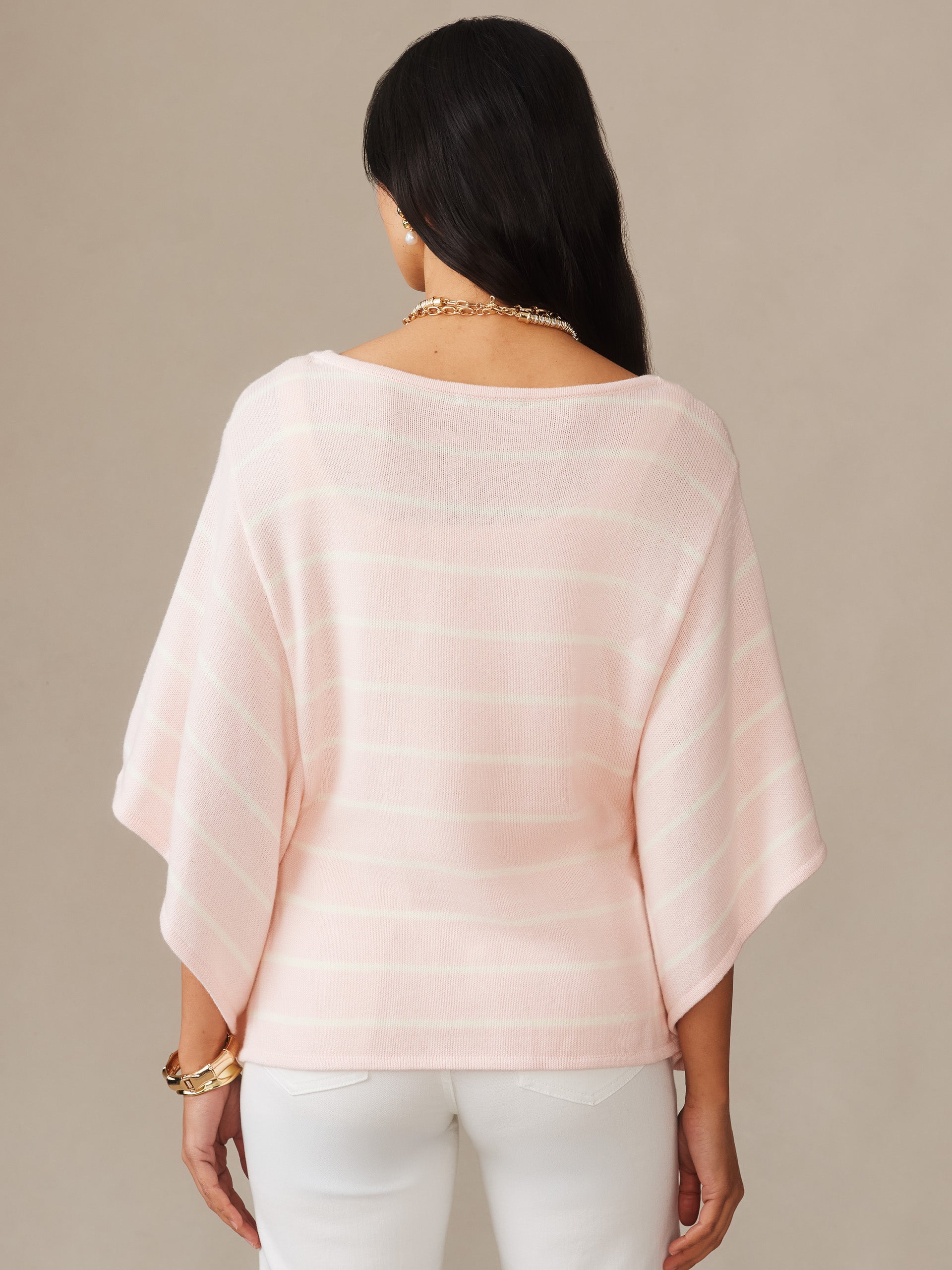 A woman models the back view of Thea Sweater in Stripe by J.McLaughlin, featuring softly striped light pink and white fabric with a relaxed fit, effortlessly stylish and enduring design.