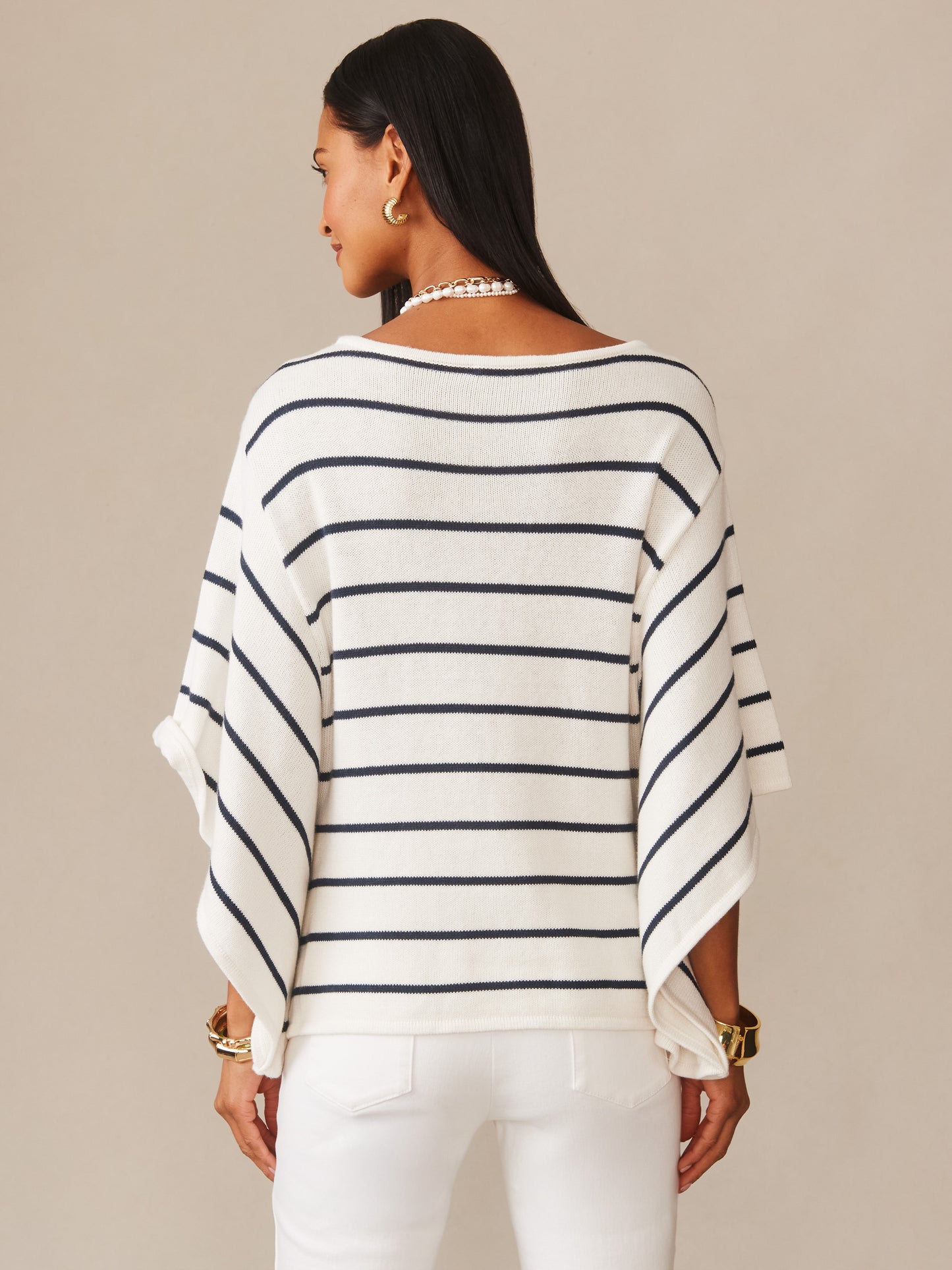 Woman wearing Thea Sweater in Stripe by J.McLaughlin, featuring classic navy stripes on white fabric, embodying effortlessly stylish, enduring designs with a legacy of timeless fashion.