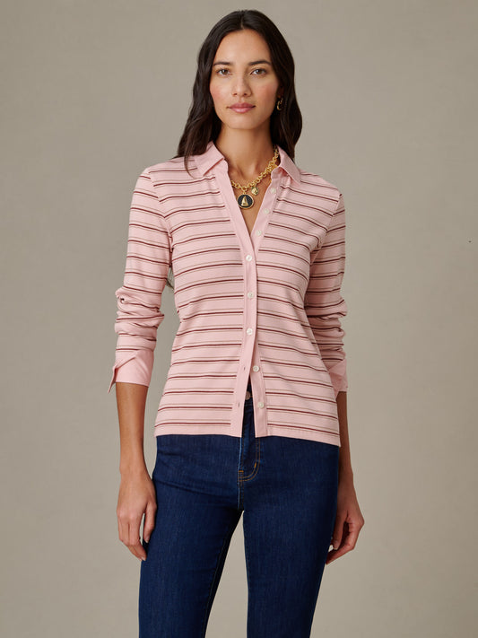 Woman wearing Theodora Shirt in Stripe by J.McLaughlin, featuring soft pink and brown horizontal stripes with a classic collar and button-down front, paired with dark blue jeans.