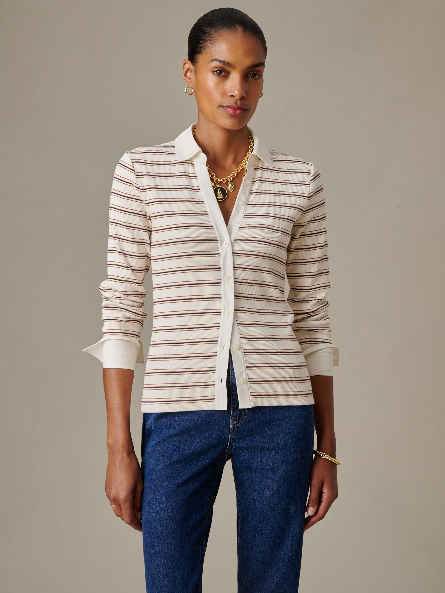 Woman wearing Theodora Shirt in Stripe by J.McLaughlin, styled with classic denim, showcasing effortless style and enduring design in a timeless striped top.