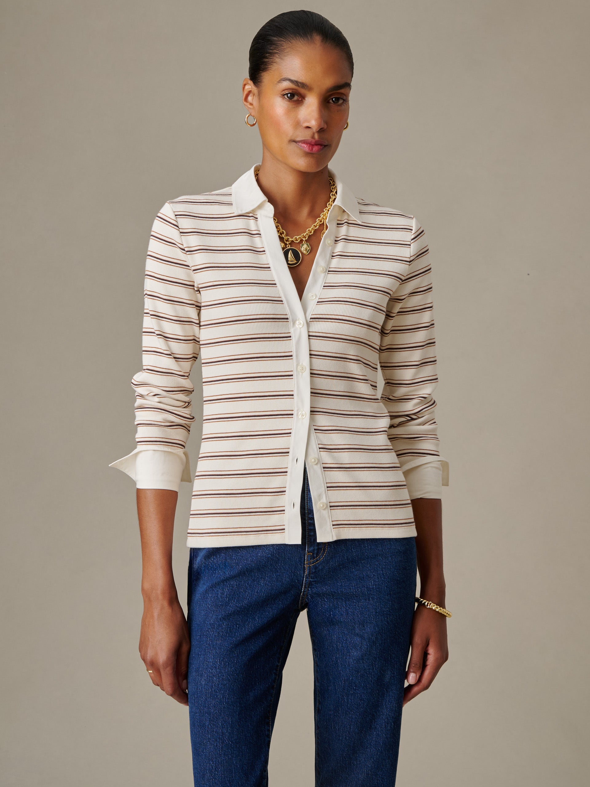 Woman wearing Theodora Shirt in Stripe by J.McLaughlin, styled with classic denim, showcasing effortless style and enduring design in a timeless striped top.