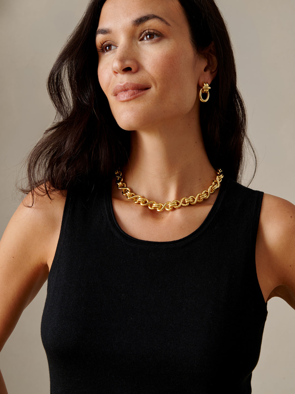 J.McLaughlin Thick Chain Necklace worn by a woman with a black sleeveless top and matching gold hoop earrings for effortlessly stylish appeal