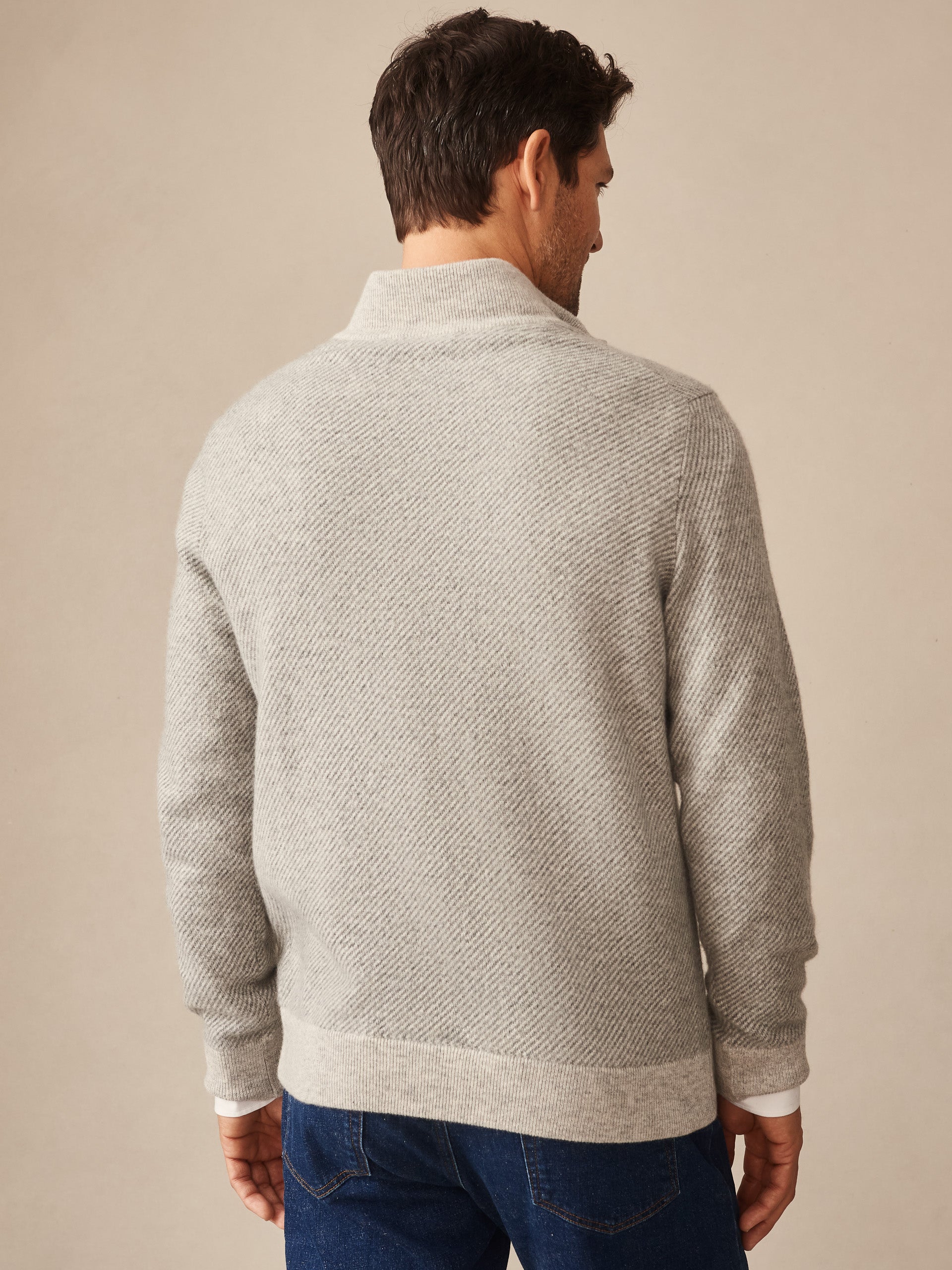 Man wearing a gray Twain Cashmere 1/4 Zip in Jacquard sweater by J.McLaughlin, showcasing effortlessly stylish, enduring designs with innovative fabrics, a destination for defining style. Life, Well-Lived.