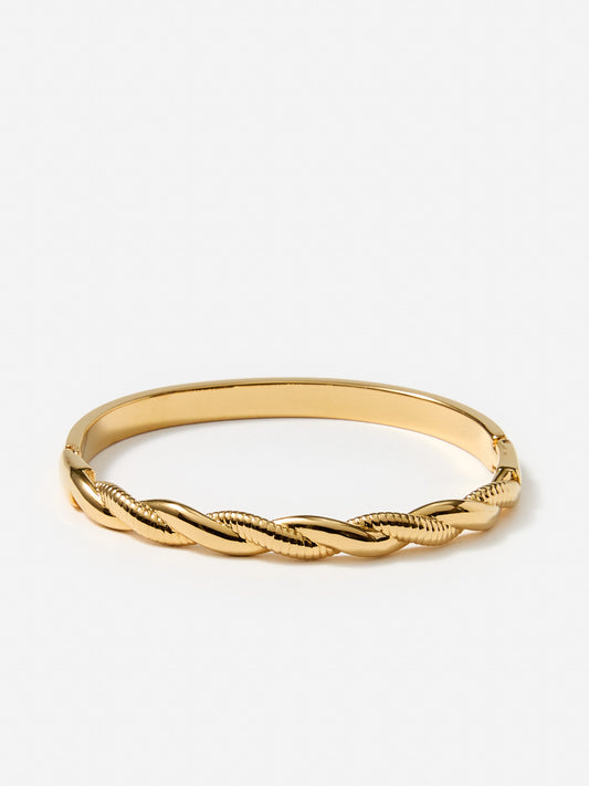 J.McLaughlin twist hinge bangle in gold made with brass.