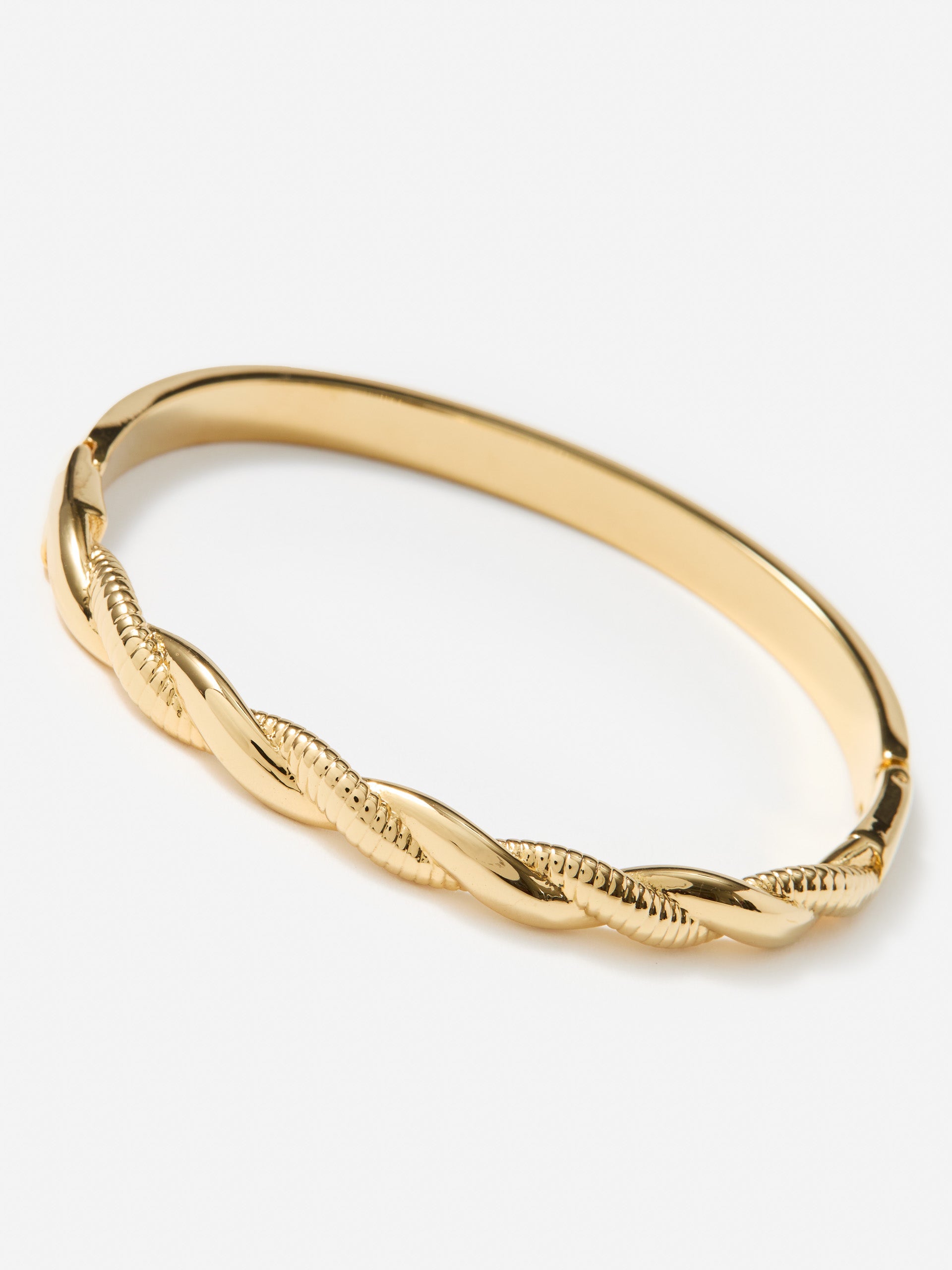 J.McLaughlin twist hinge bangle in gold made with brass.