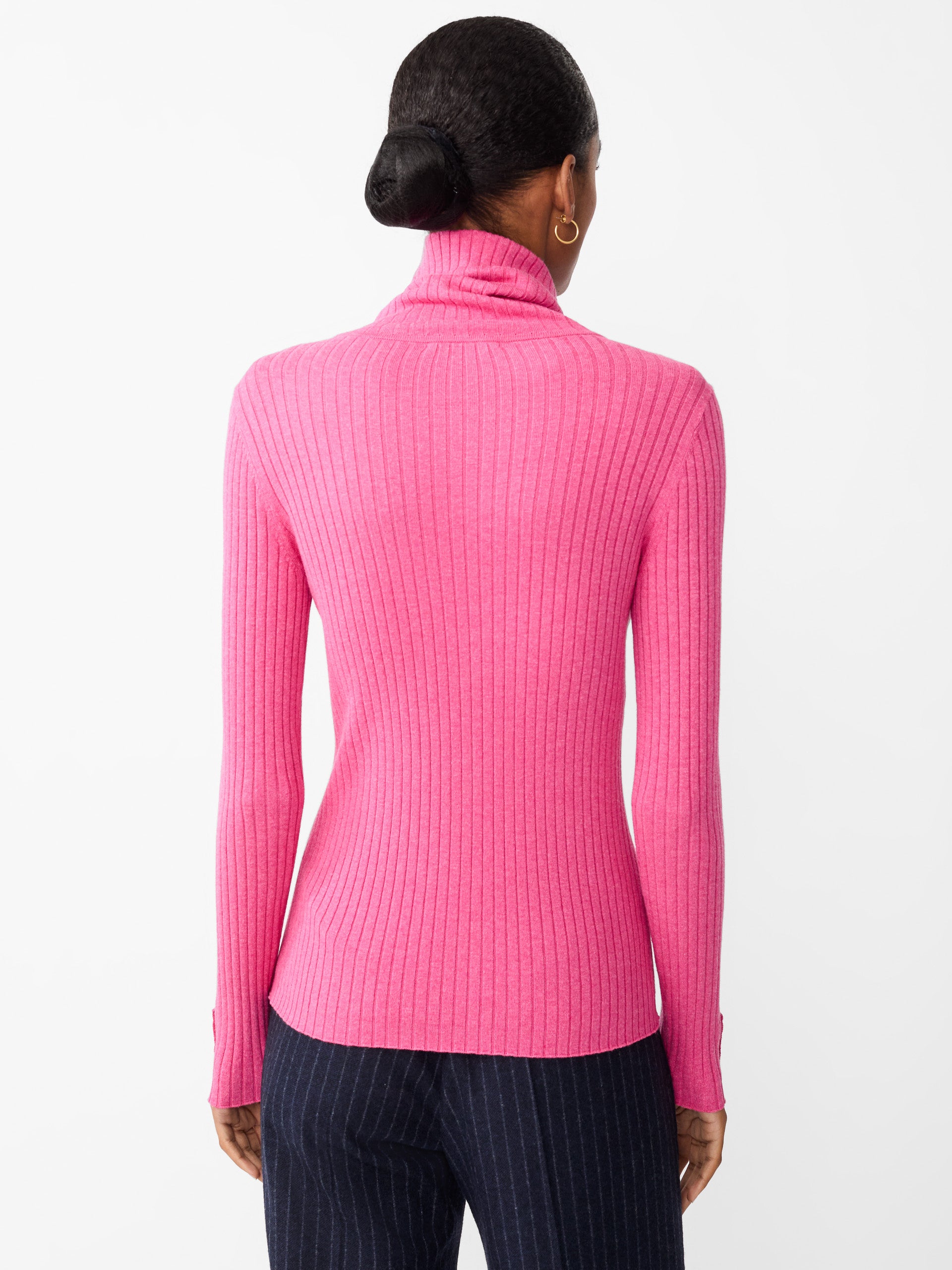 Model wearing J.McLaughlin Arlette turtleneck in heather blush made with cotton/modal.