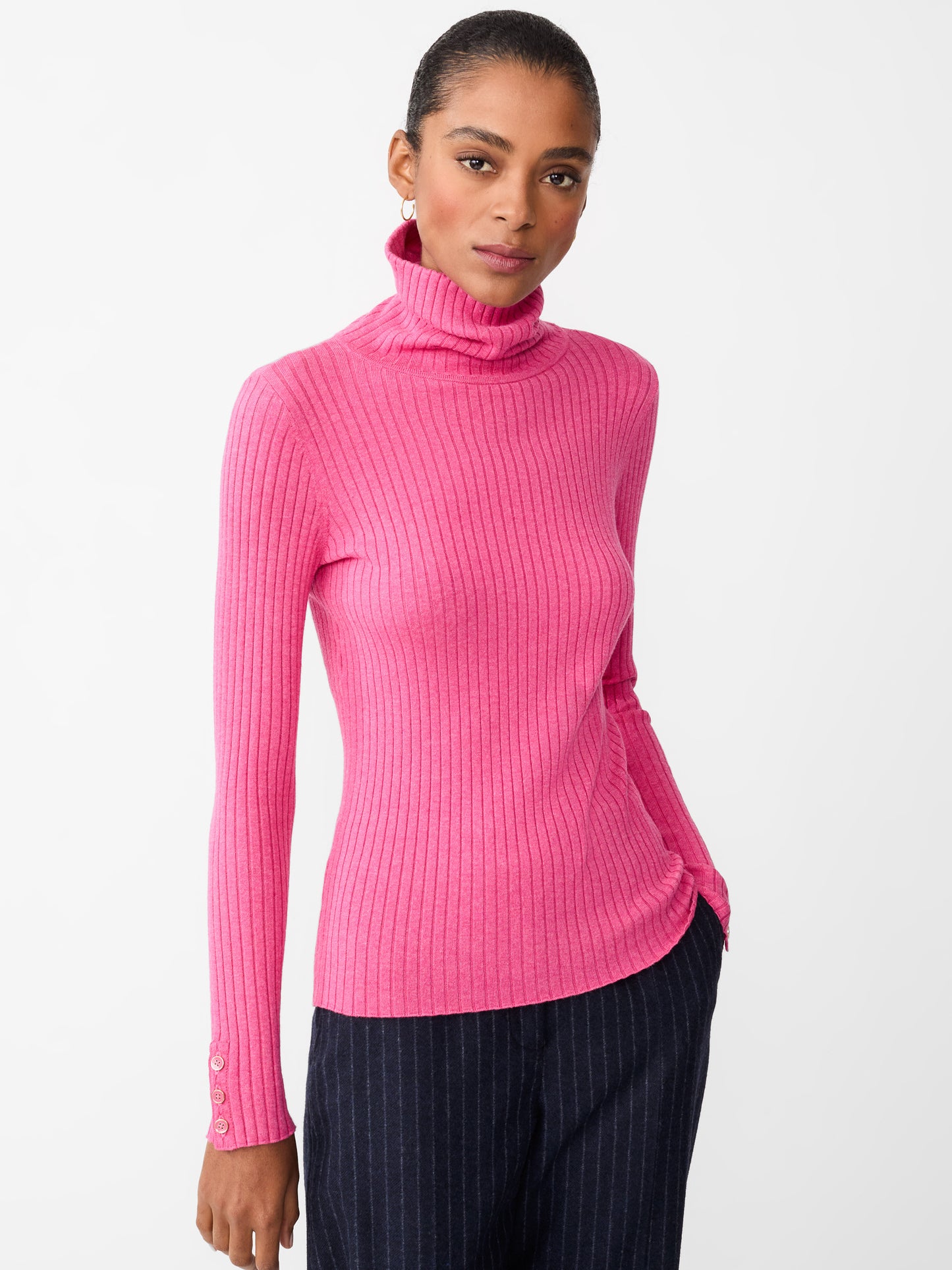 Model wearing J.McLaughlin Arlette turtleneck in heather blush made with cotton/modal.