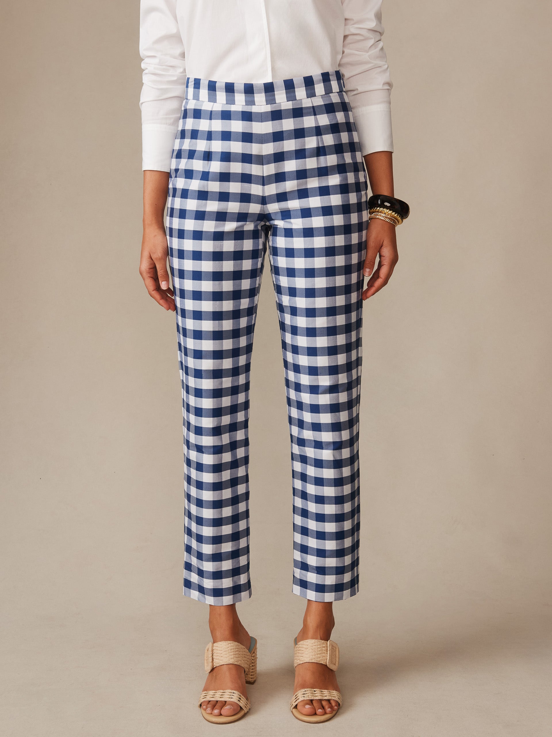 Model wearing Millbrook Silk Blend Pants in Gingham by J.McLaughlin paired with a white blouse and neutral sandals, showcasing effortlessly stylish, enduring designs with innovative fabrics.
