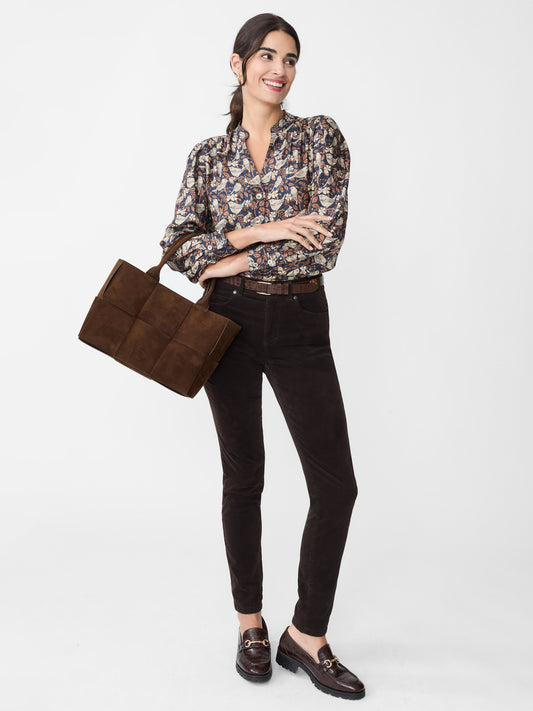 Model wearing J.McLaughlin Watson jeans in dark chocolate made with velveteen.