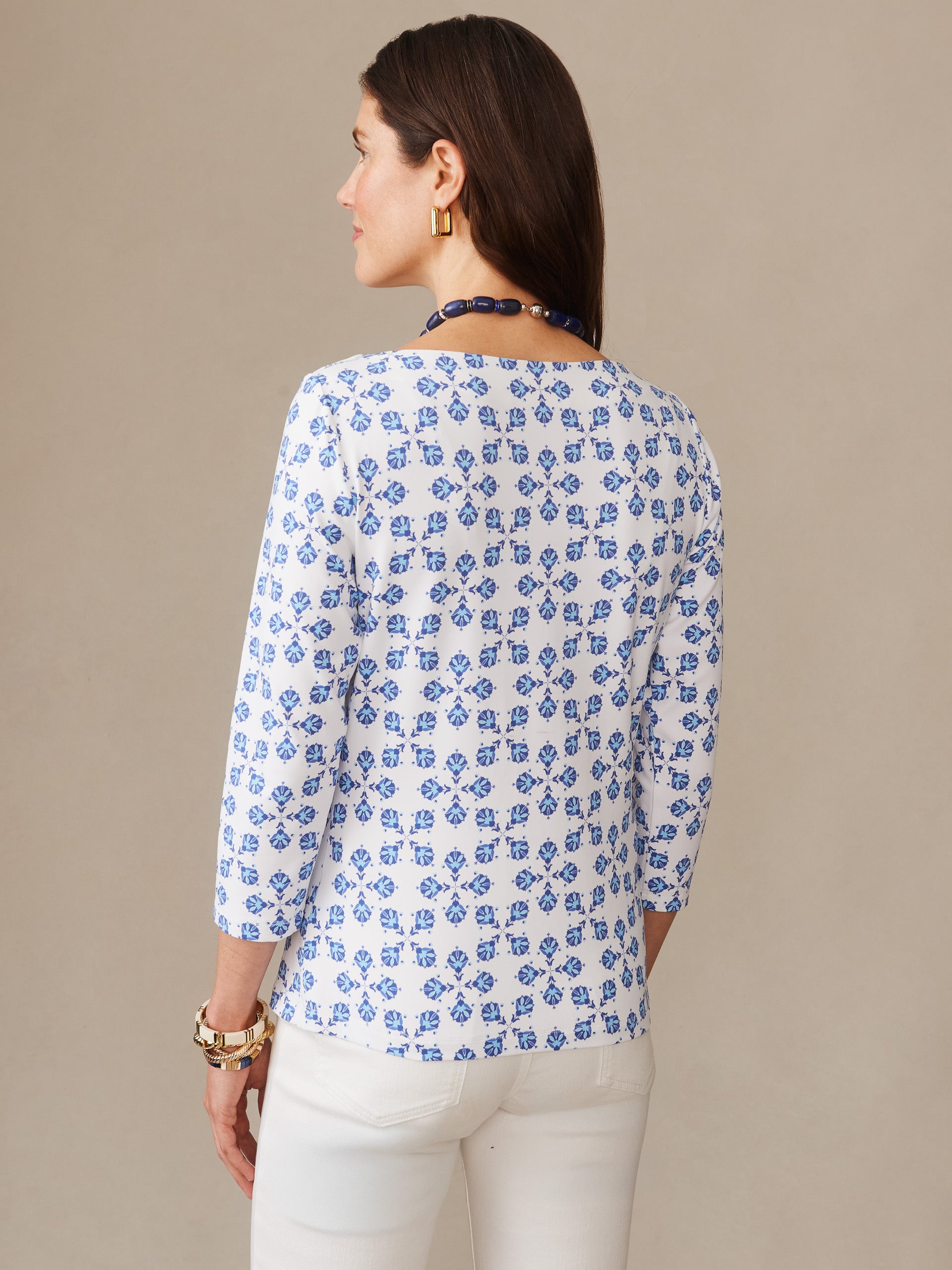 Woman wearing the Wavesong Tee in Mythic Tile by J.McLaughlin, featuring a classic blue and white pattern, effortlessly stylish with enduring designs and innovative fabrics.