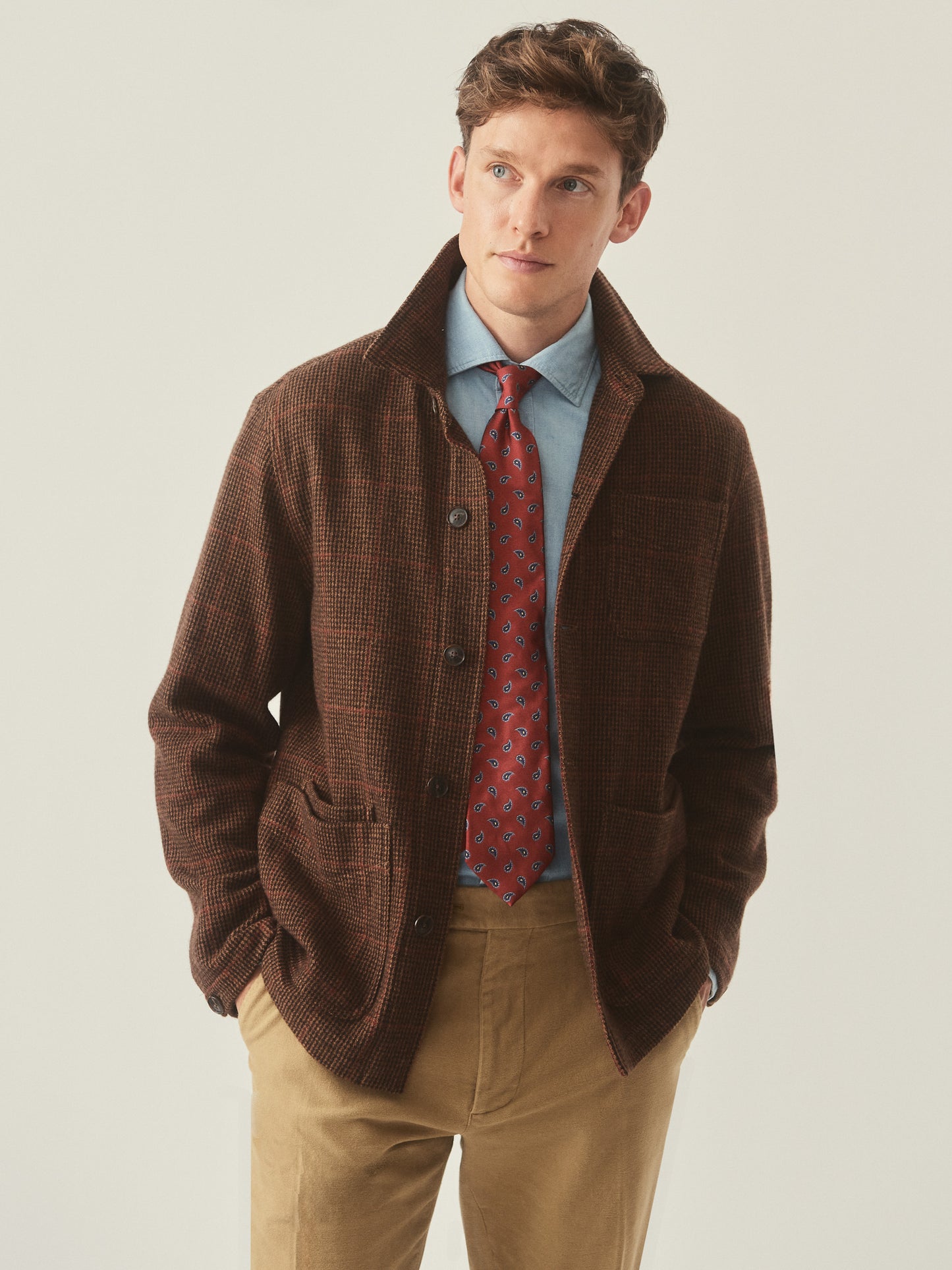 Model wearing J.McLaughlin Weekender jacket in brown/tan/red made with wool.