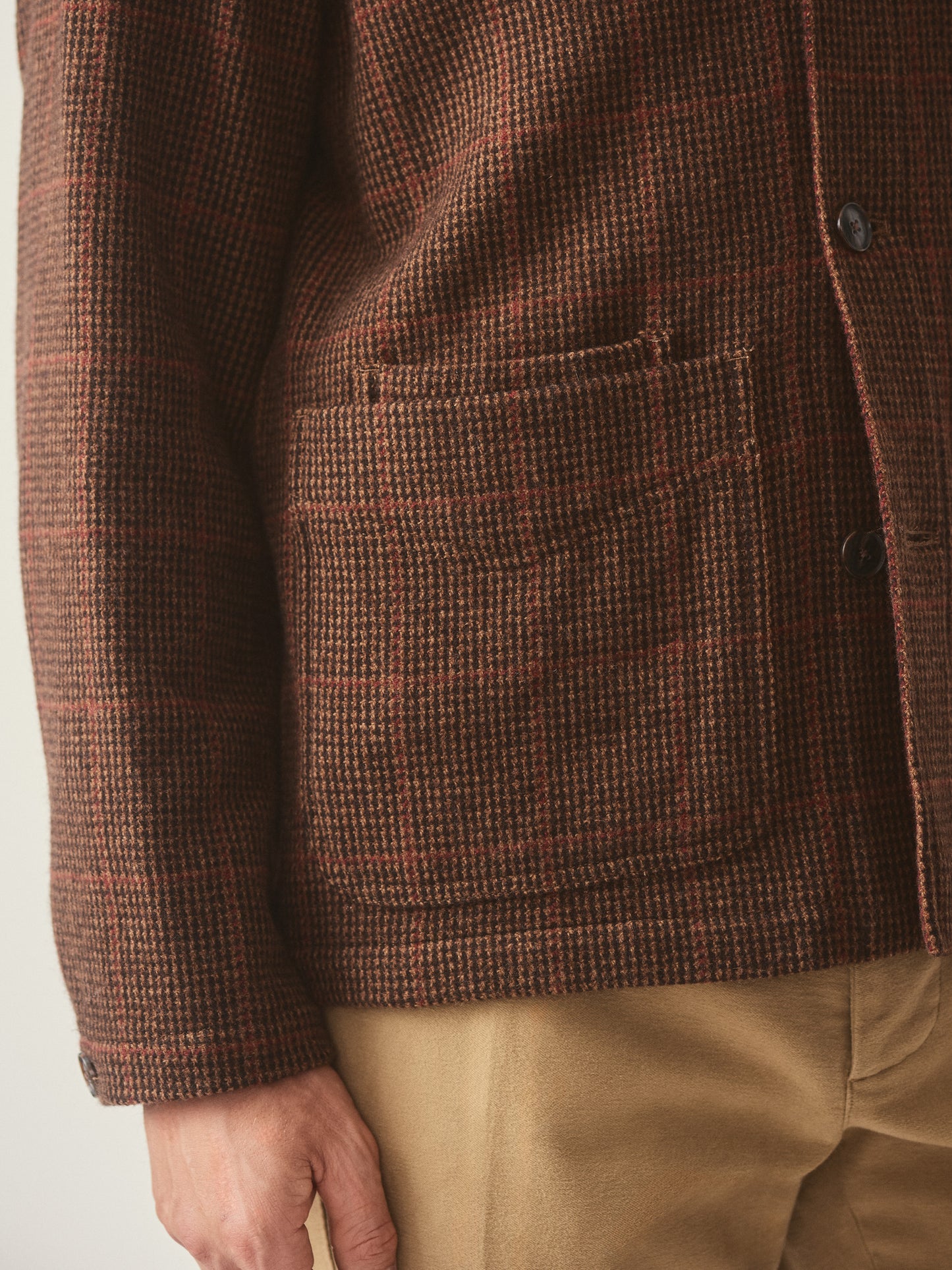 Model wearing J.McLaughlin Weekender jacket in brown/tan/red made with wool.