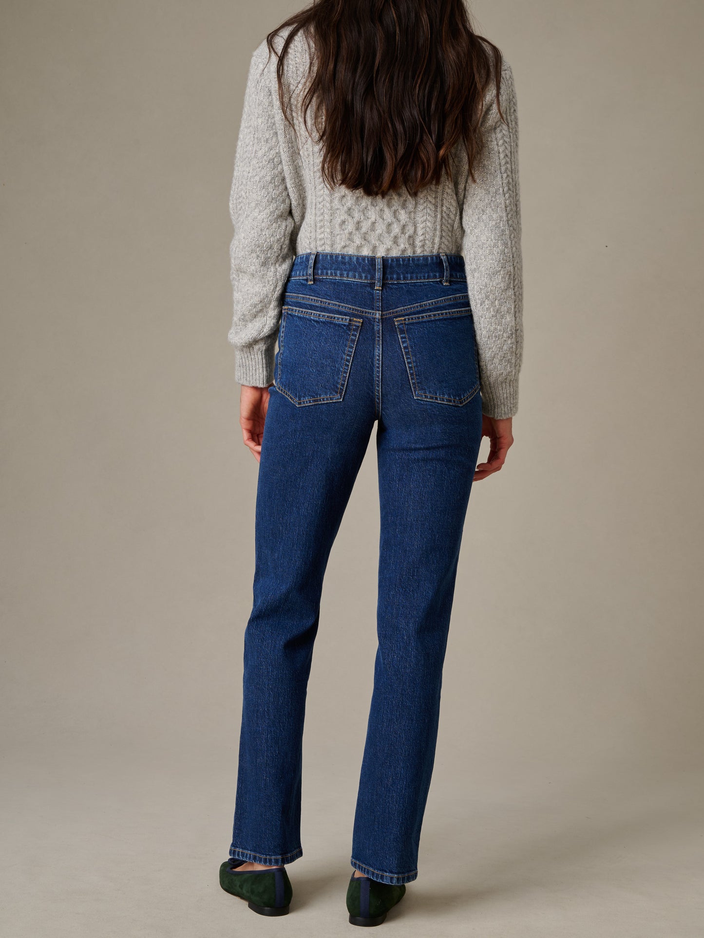 Woman wearing Willow Jeans by J.McLaughlin in classic blue denim paired with a cozy knit sweater, showcasing an effortlessly stylish look with enduring design.