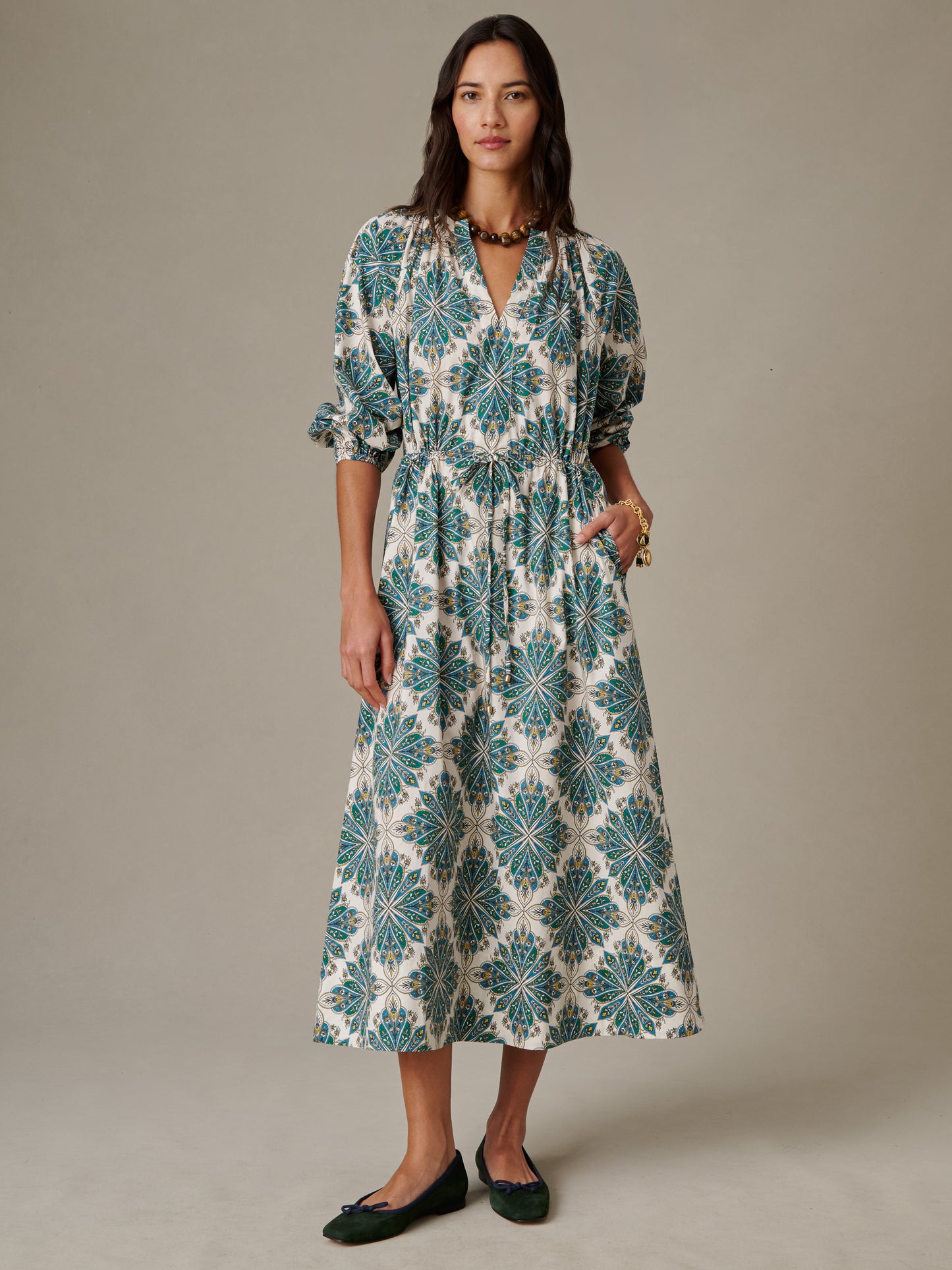 Woman wearing the Winslet Dress in Neo Radiant by J.McLaughlin, featuring a stylish patterned midi length design with puffed sleeves, embodying effortlessly stylish, enduring designs.